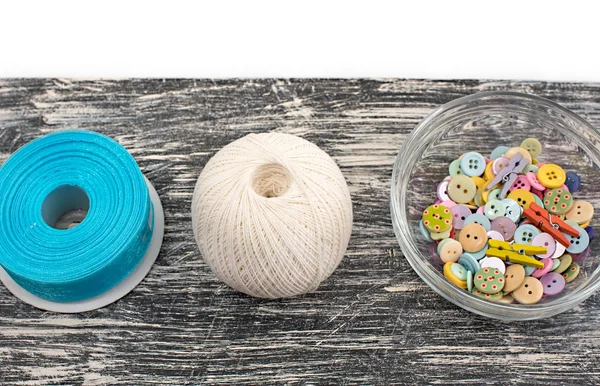 Colored buttons in glass Cup on old wooden Board — Stock Photo, Image