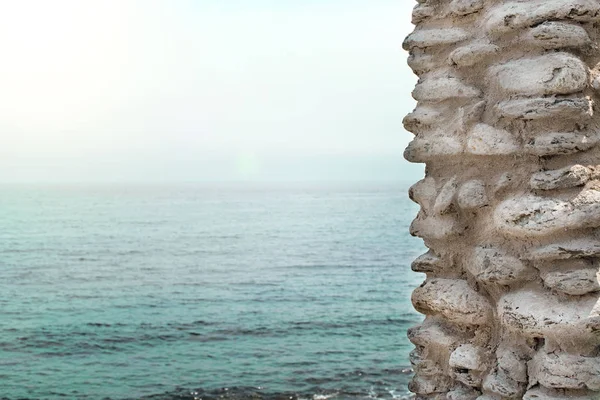 Parte de la pared de piedra contra el mar — Foto de Stock