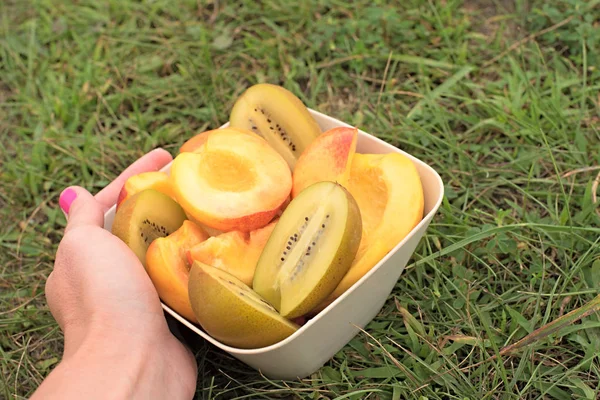 Fruit Cup stands on a wooden table.