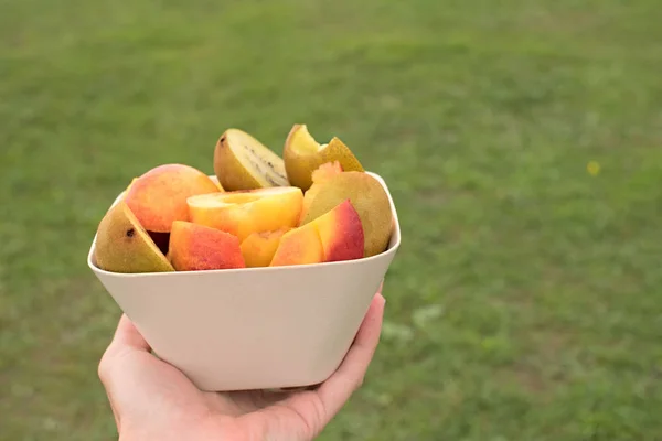 Fruit Cup stands on a wooden table.