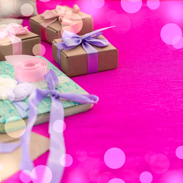 Gifts Packed in Kraft boxes tied with satin ribbon.