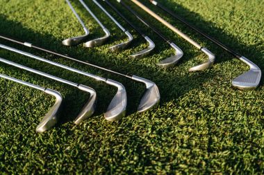 Golf clubs on grass clipart
