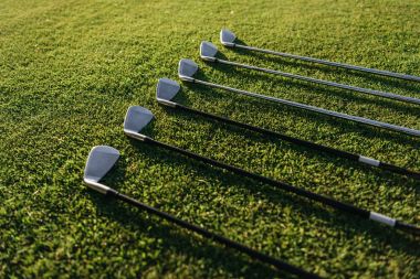 Golf clubs on grass clipart