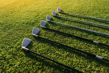 Golf clubs on grass clipart