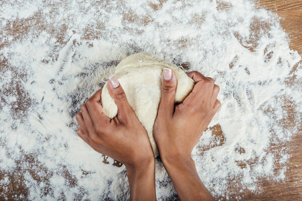 hands kneading dough  