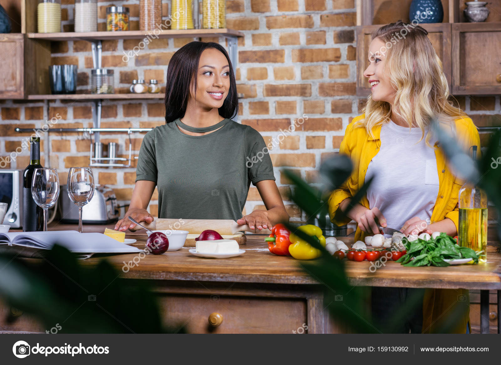 Women cooking in kitchen — Stock Photo © IgorVetushko 159130992