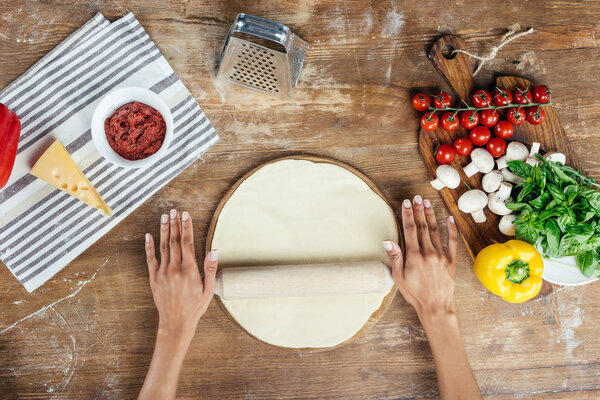 Hands rolling dough 