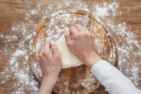 hands kneading dough  