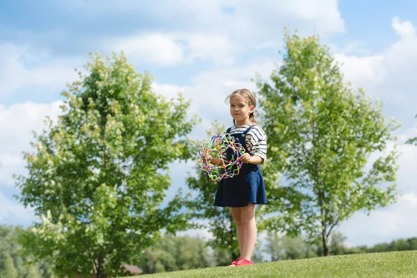 Girl playing with toy in park — Stock Photo, Image