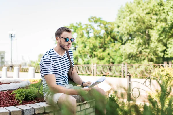 Young man with map — Free Stock Photo