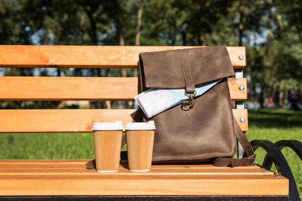 Leather bag and paper cups
