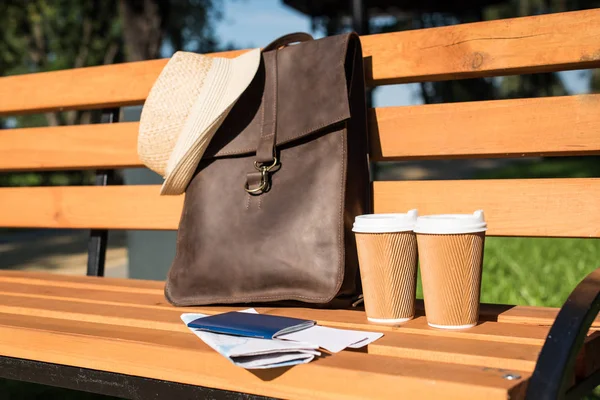 Leather bag and paper cups — Stock Photo, Image