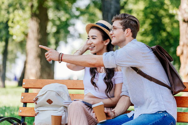multicultural couple sitting on bench
