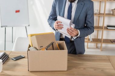 fired businessman packing things clipart