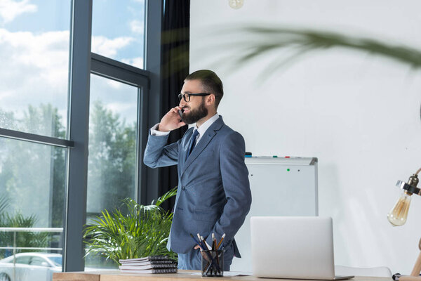 businessman talking on smartphone at workplace