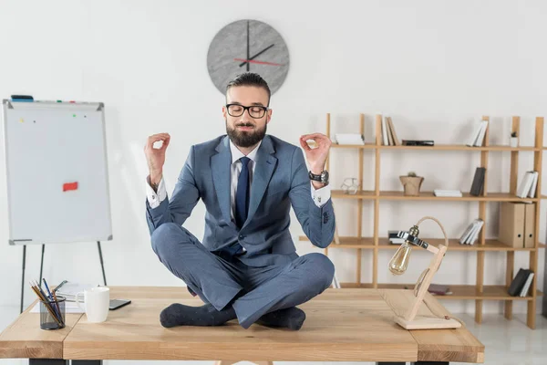 Businessman sitting in lotus position — Stock Photo, Image