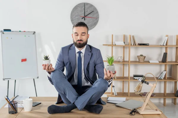 Businessman sitting in lotus position — Stock Photo, Image
