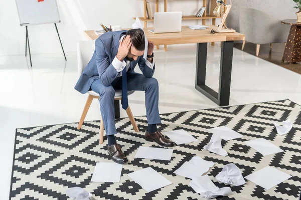 Stressed businessman looking at papers — Stock Photo, Image