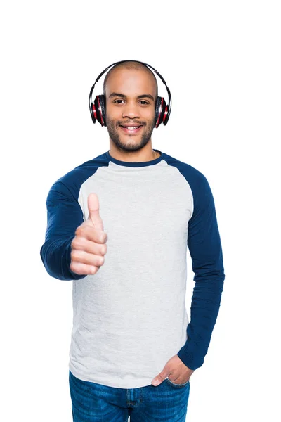 Man in headphones with thumb up — Stock Photo, Image