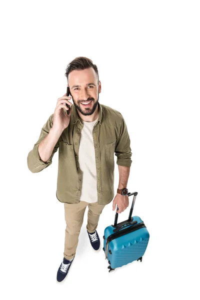 Man with suitcase talking on smartphone — Stock Photo, Image