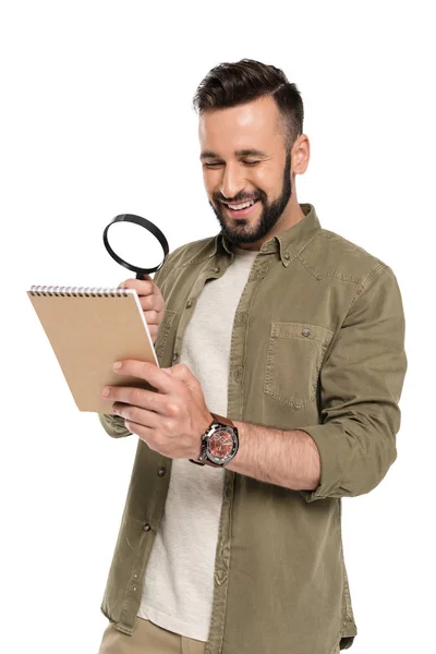 Man with magnifying glass and notebook — Stock Photo, Image