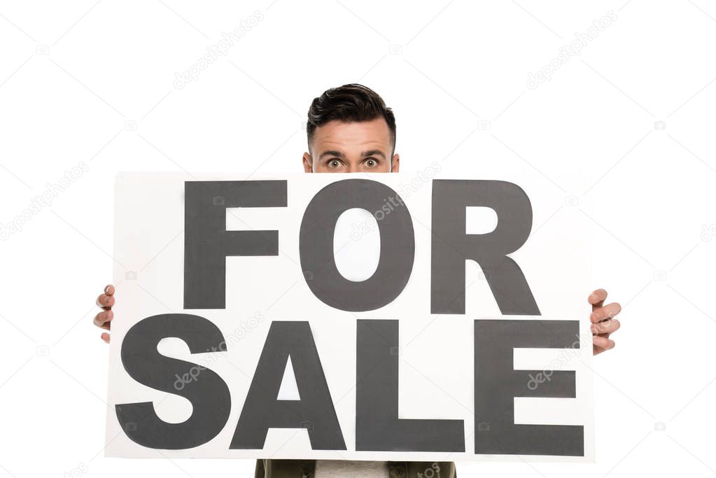 Obscured view of man with for sale banner in hands looking at camera isolated on white