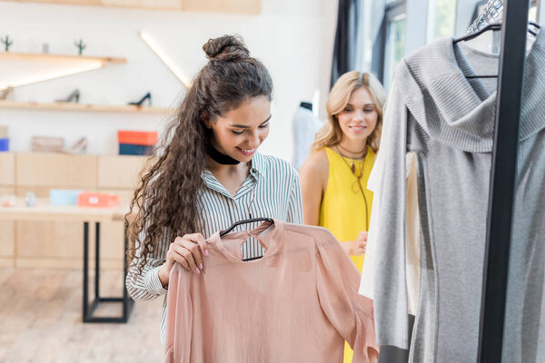 women choosing clothes in showroom