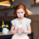 Girl drinking milkshake in cafe