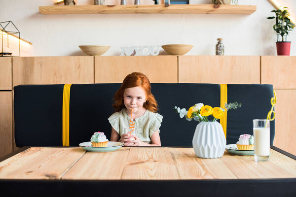 girl drinking milkshake in cafe