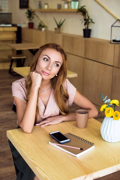 Pensive young woman in cafe — Free Stock Photo