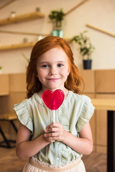 Ragazza con lecca-lecca a forma di cuore — Foto Stock