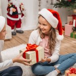 Little boy presenting gift to sister