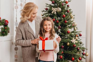 mother and daughter with christmas gift clipart