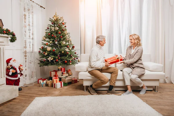 man presenting gift to beautiful woman