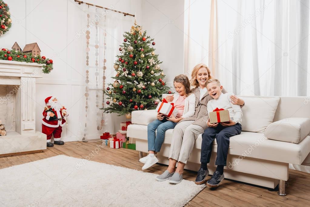 woman and kids with christmas gifts