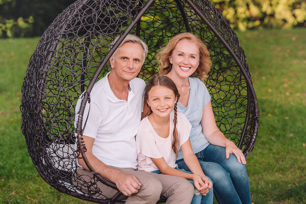 grandparents and granddaughter in garden