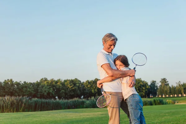 Grandfather and granddaughter in park