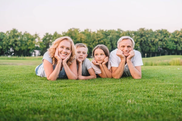 Familia acostada en el prado — Foto de Stock