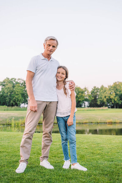 smiling grandfather and granddaughter