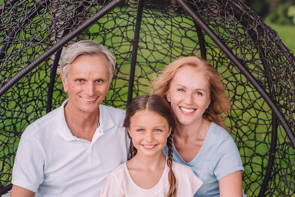 grandparents and granddaughter in garden