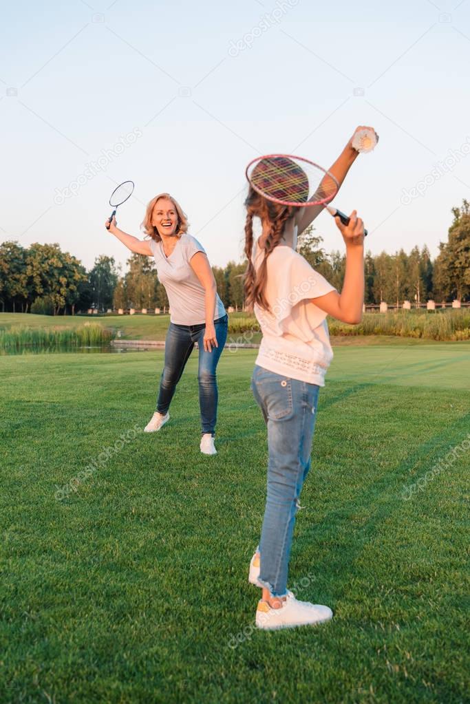 woman and granddaughter playing badminton