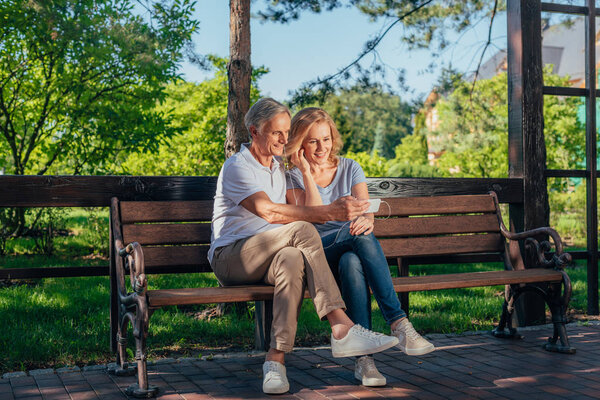 senior couple using smartphone together