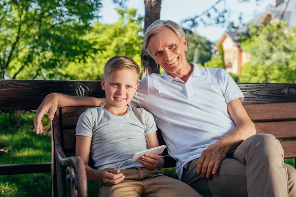 Family with smartphone in park — Stock Photo, Image