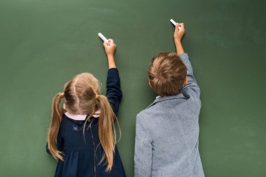 pupils writing on chalkboard clipart