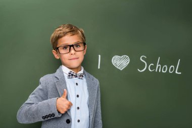schoolboy showing thumb up sign clipart