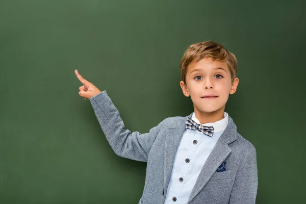 School boy pointing at copy space — стоковое фото