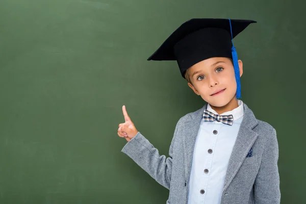 School boy pointing at copy space — стоковое фото