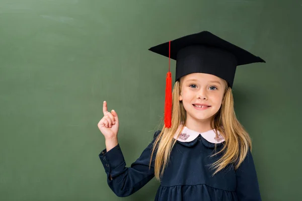 Schoolgirl in graduation hat — Stock Photo, Image