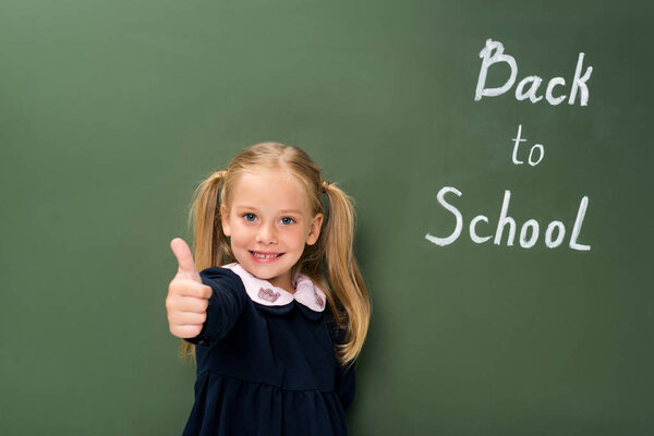 schoolgirl showing thumb up
