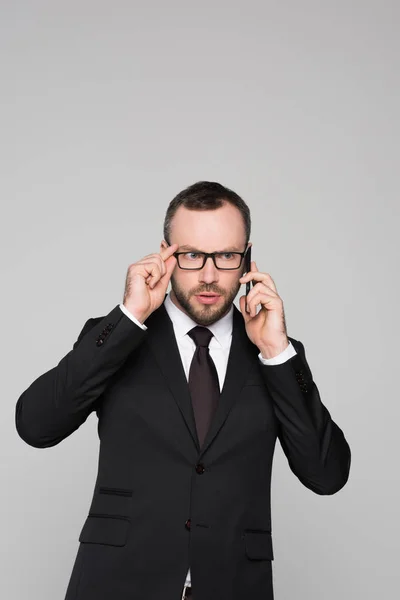 Concerned young businessman talking on phone — Stock Photo, Image